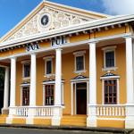 **

A colonial-era building in Suva, Fiji, standing tall, representing the lasting impact of British architecture and administration.

**
